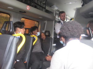 Students sit inside a police carrier as an officer demonstrates what equipment they have available.